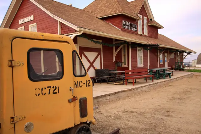 Carlyle train station museum with a railway motor car